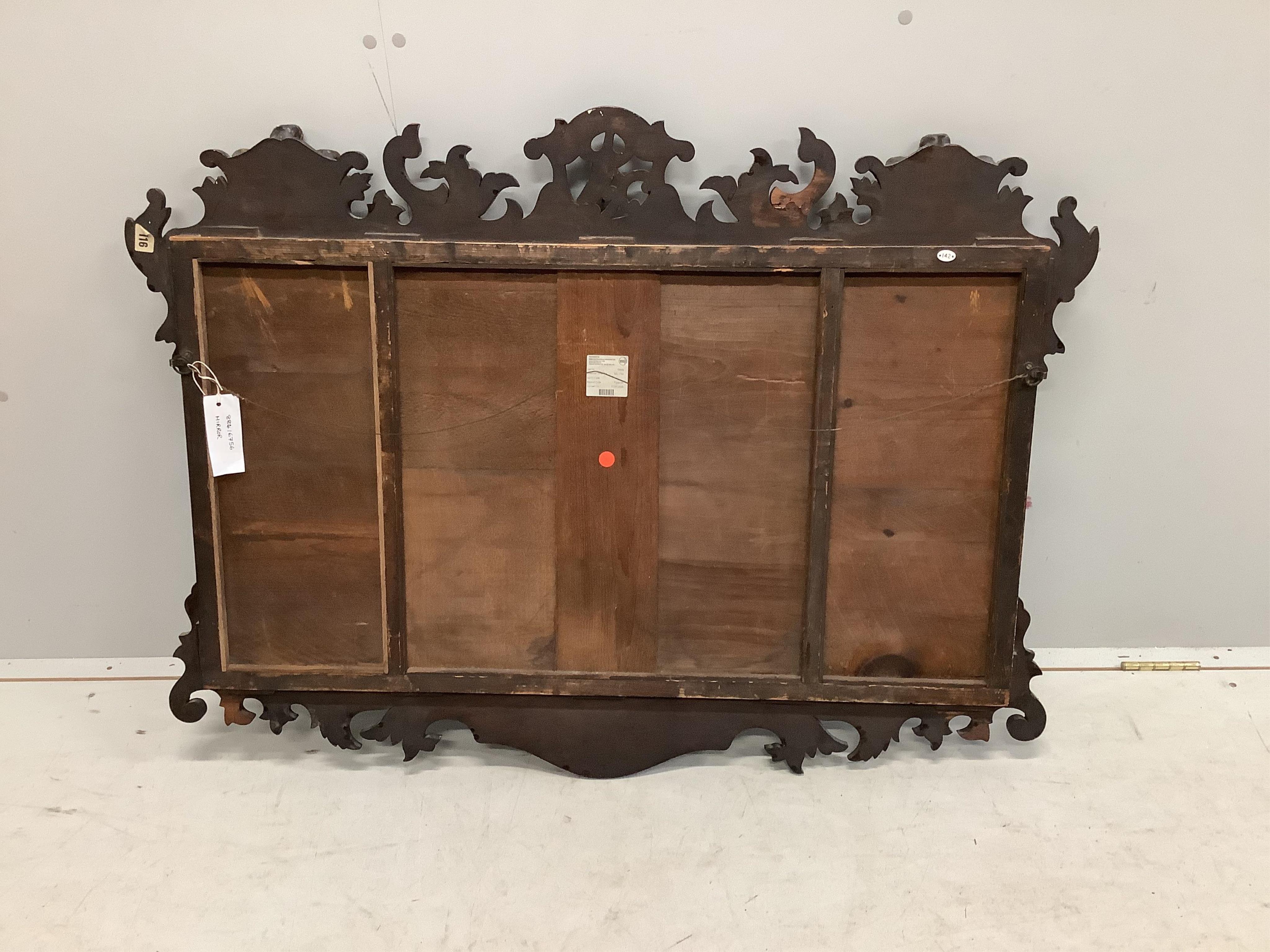 A George III style mahogany, parcel gilt triple plate fret cut wall mirror with Prince of Wales plume and phoenix pediment, width 114cm, height 84cm. Condition - fair to good